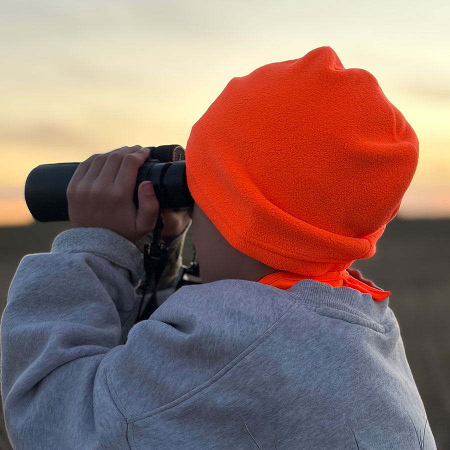 Child using binoculars while hunting