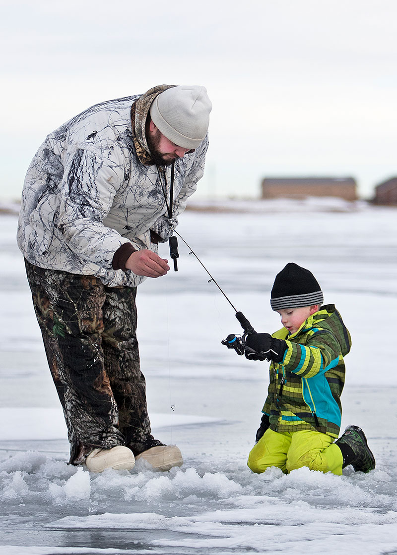 Man and child ice fishing