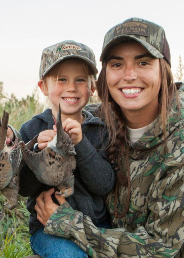 Woman and child hunters with harvested doves