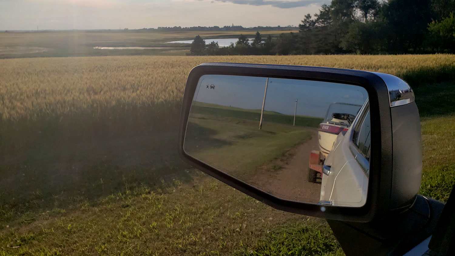 Boat on trailer in truck rearview mirror