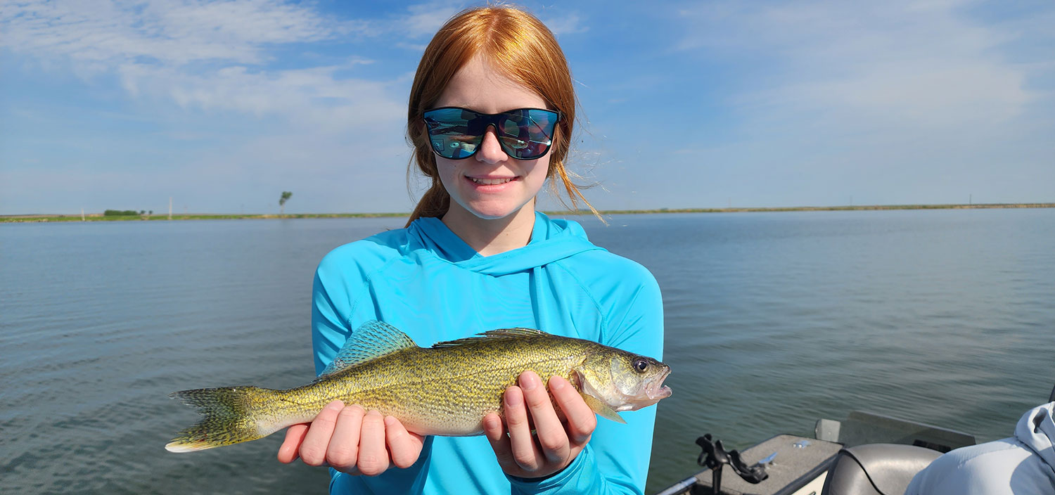 Teen holding walleye she caught