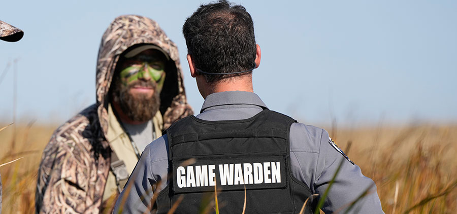 Warden with hunter in the field