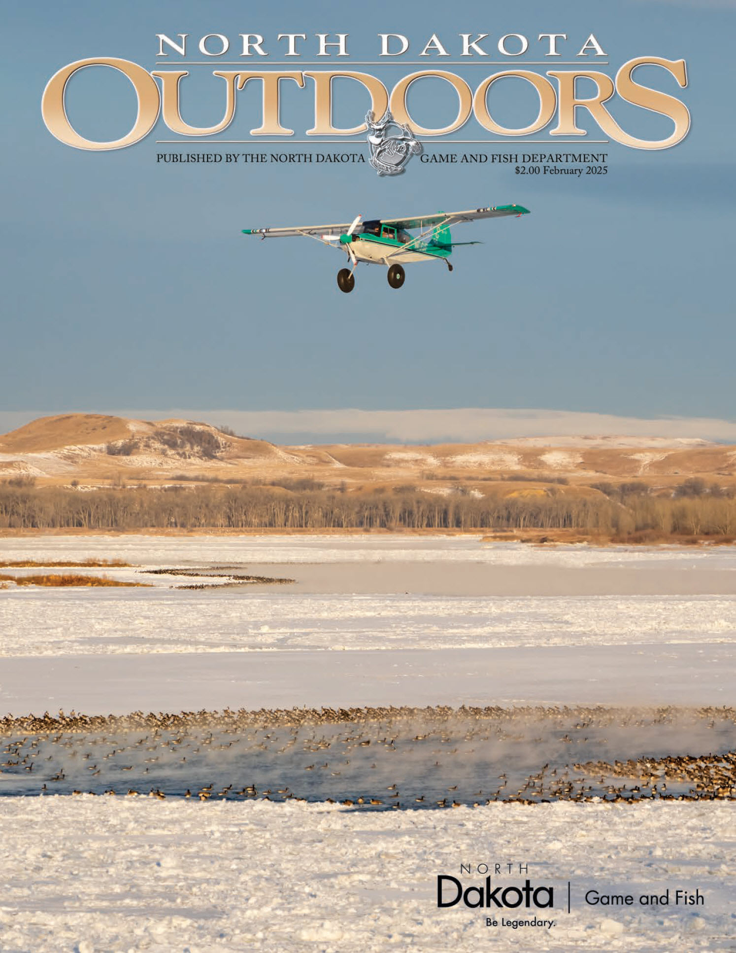 Magazine cover - small plane flying over geese on frozen river doing winter waterfowl counts