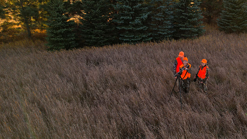 Man and two young women deer hunting