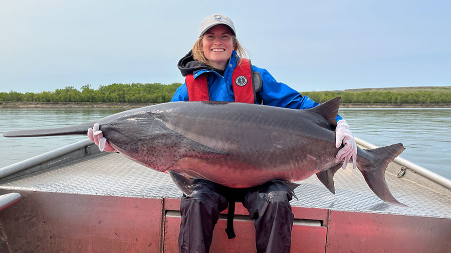 Cayla holding a 110lb paddlefish