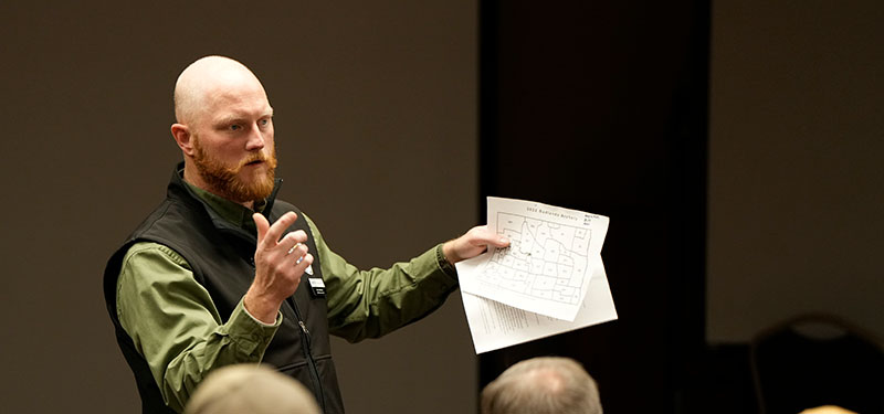Casey speaking at a meeting