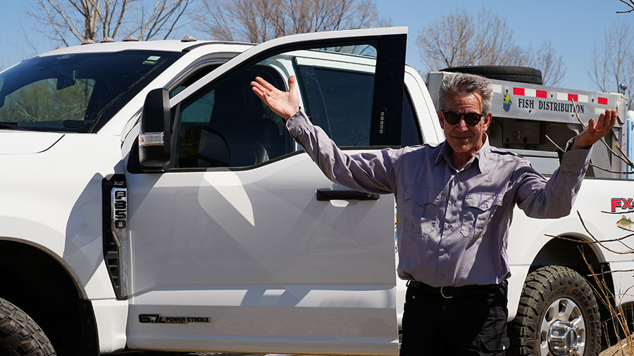 Jerry Weigel by fish transport truck