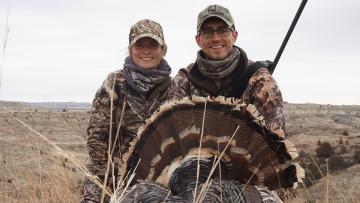 Author and husband with turkey after a hunt