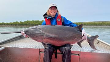 Cayla holding a 110lb paddlefish