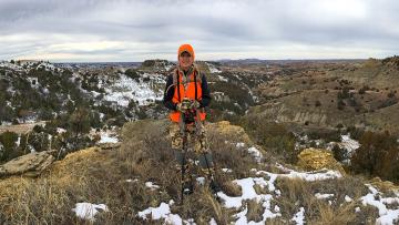 Sandy on top of hill while out hunding in the badlands.
