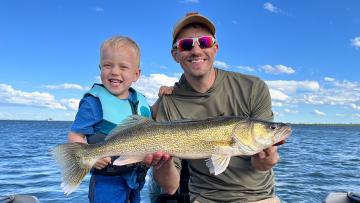 Father and son with fish they caught