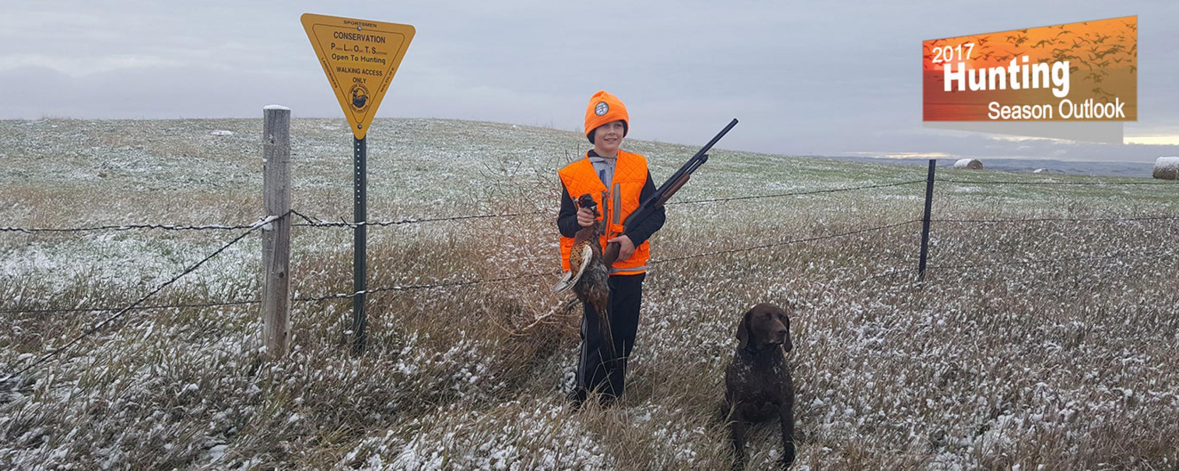 Kid with pheasant and dog