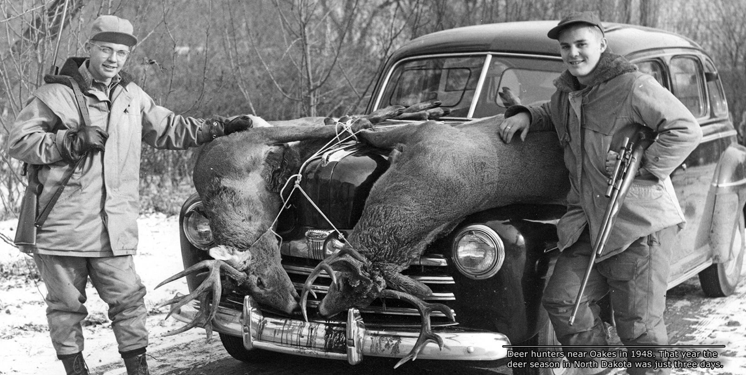 Kids with deer strapped to front of car