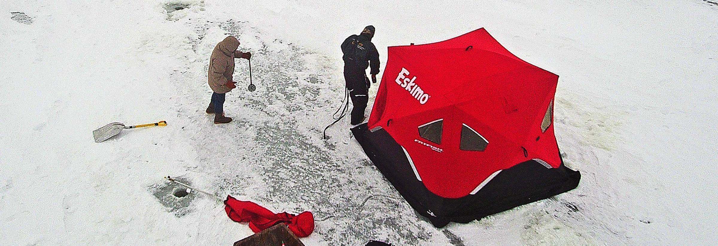 Ice house with two anglers setting up