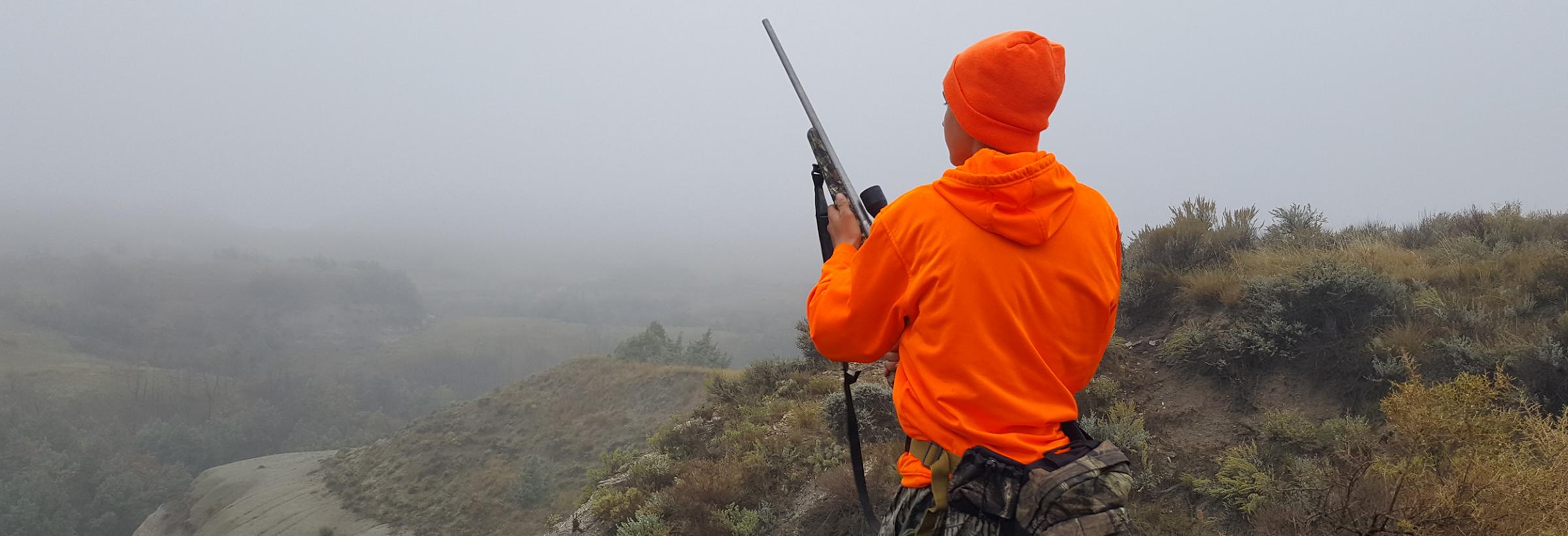 Young deer hunter in the badlands