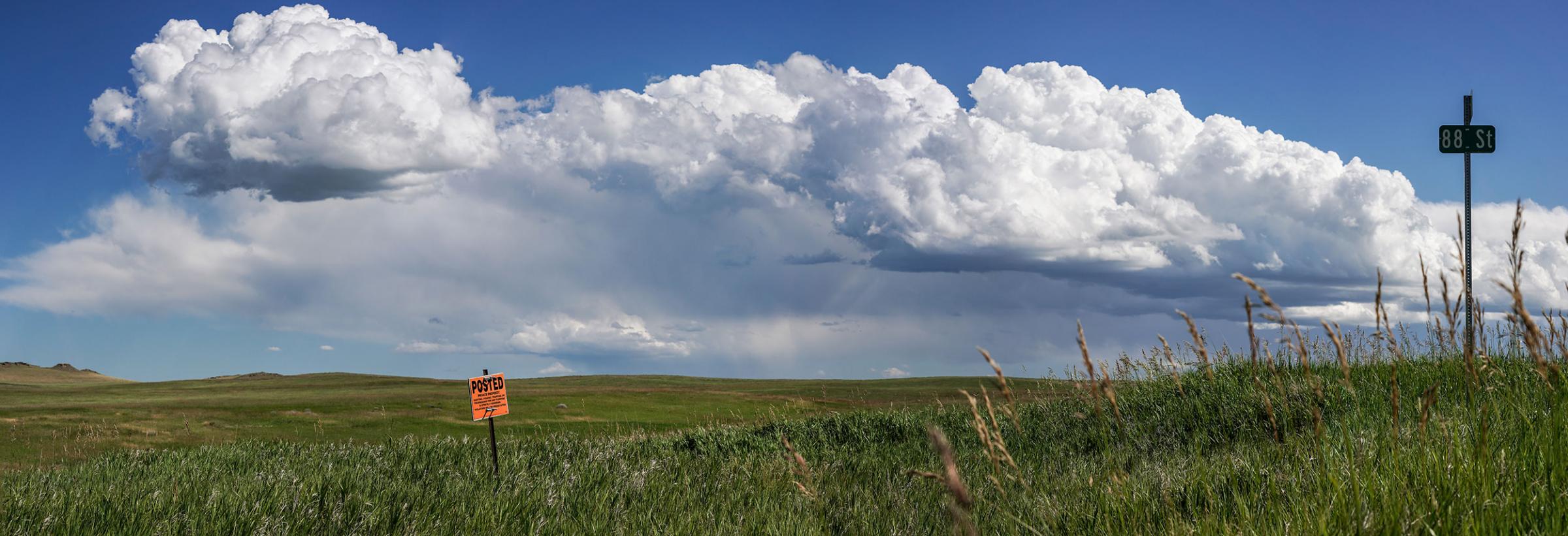 Prairie with posted sign