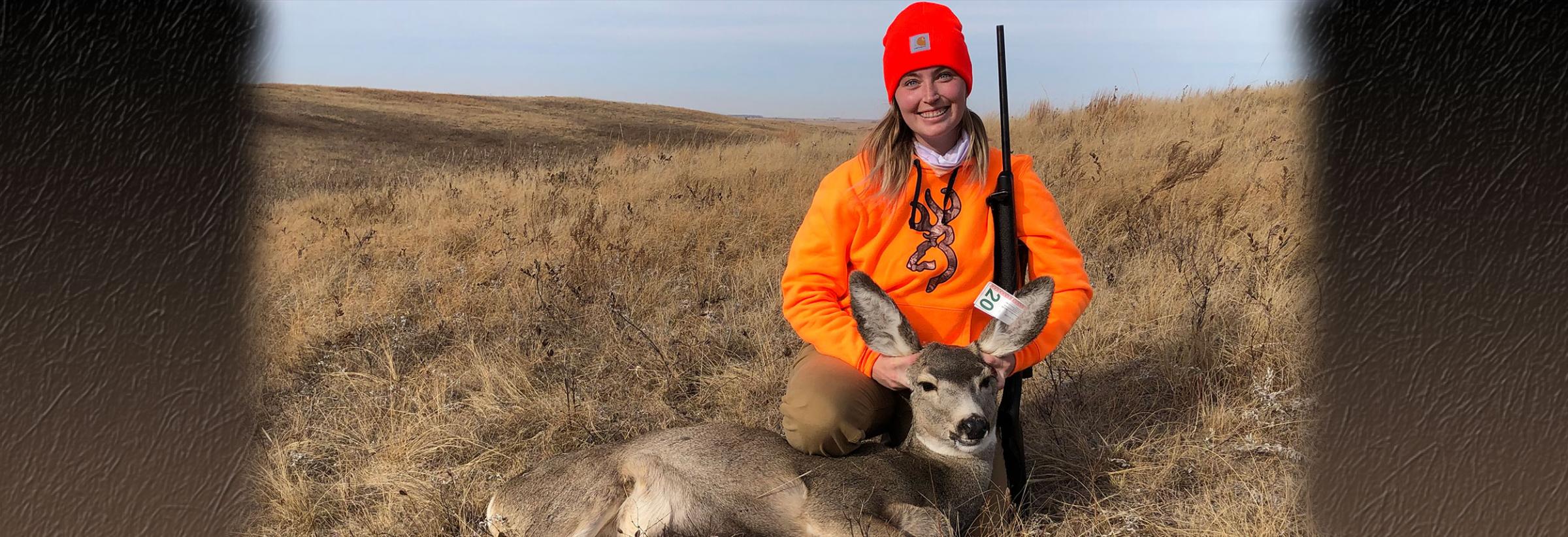 Hunter posing with deer she harvested