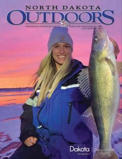 2022 January Outdoors cover of woman holding a fish caught while ice fishing
