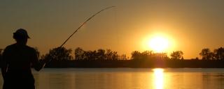 Woman fishing at sunset