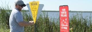 Worker putting up signs