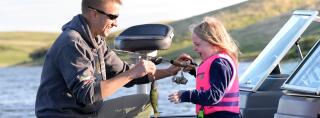 Dad and daughter with fish she caught