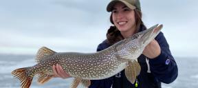 Woman holding northern pike