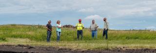 Landowners and Department personnel at a wetlands restoration project site