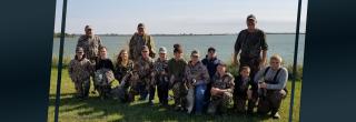 Young hunters with mentors after a successful hunt