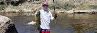 Kid holding a fish he caught