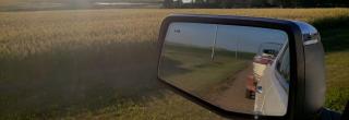 Boat on trailer in truck rearview mirror