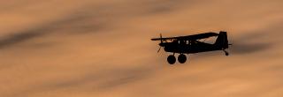 Plane flying with clouds behind