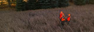 Man and two young women deer hunting