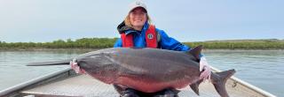 Cayla holding a 110lb paddlefish