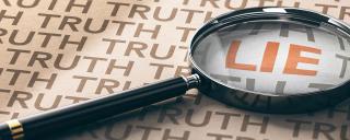 Magnifying glass over the word "Lie"