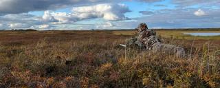 Hunter glassing on prairie