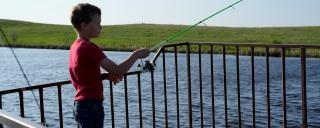 Child Fishing on Pier