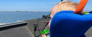 Fisch in the boat watching the water go by