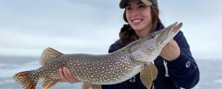 Woman holding northern pike