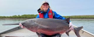 Cayla holding a 110lb paddlefish