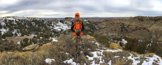 Sandy on top of hill while out hunding in the badlands.