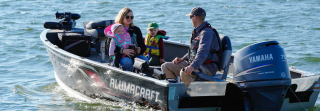 Family on boat wearing life jackets