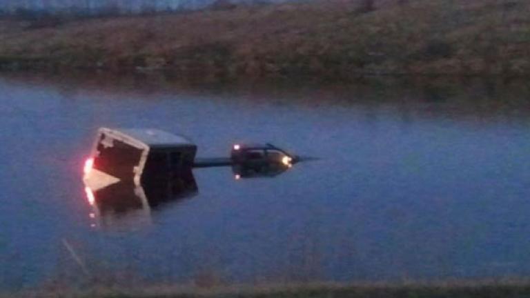 Truck and trailer in water