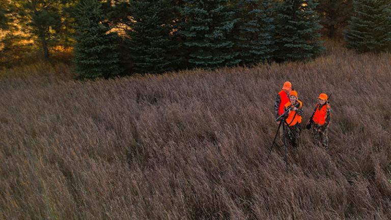 Man and two young women deer hunting