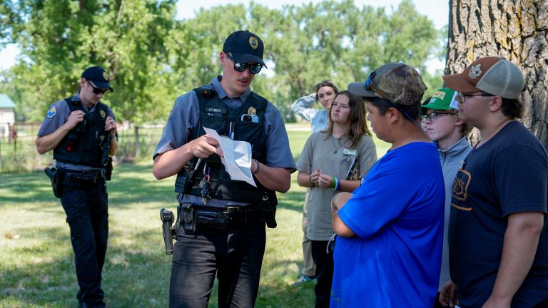 Game wardens talking to kids at camp