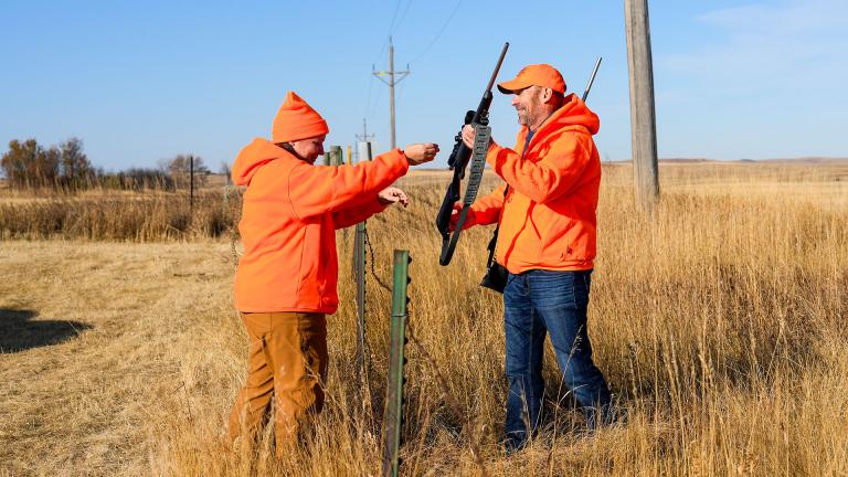 Hunters crossing fence