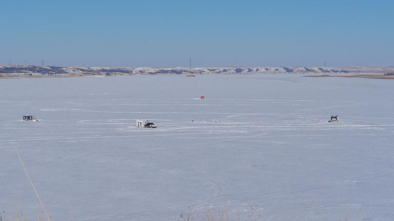 Ice houses on a frozen lake