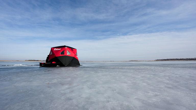 Ice house on frozen lake