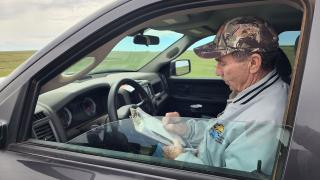 Jerry Kobriger in truck doing survey
