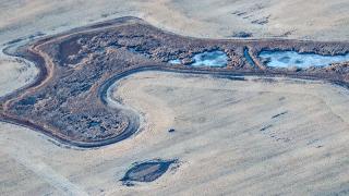 Truck in field as seen from air