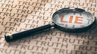 Magnifying glass over the word "Lie"